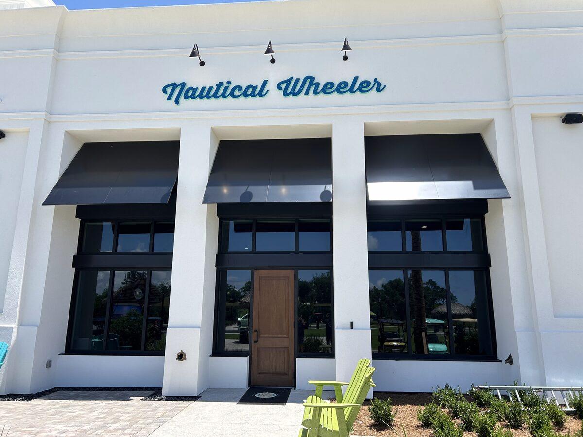 Nautical Wheeler script signage and fabric awnings — Latitude Margaritaville Watersound, FL — by CG Signs