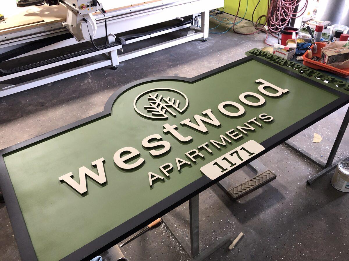 Carved HDU sign with raised letters, textured background, and reflective vinyl accents — CG Signs Jacksonville FL