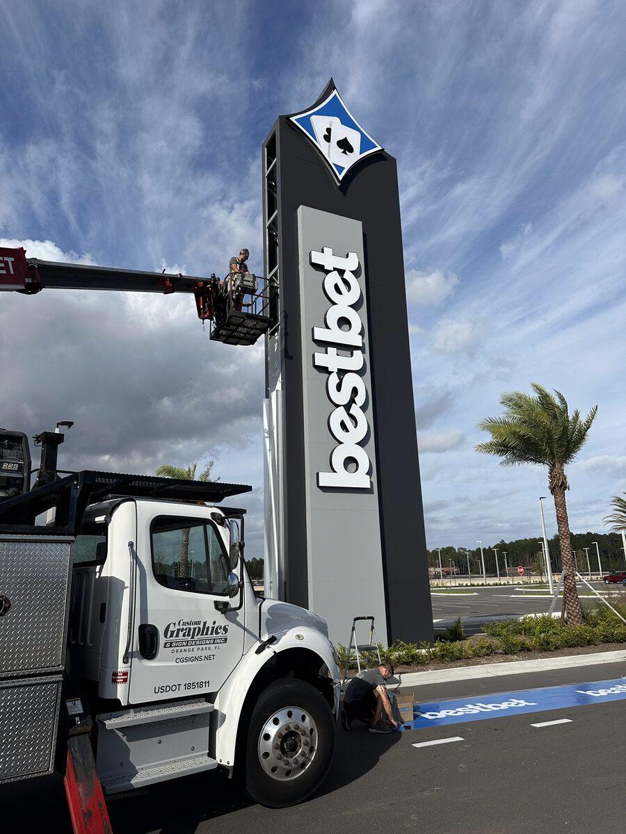 Installation of the custom-shaped pylon sign for Bestbet in St. Augustine FL — by CG Signs