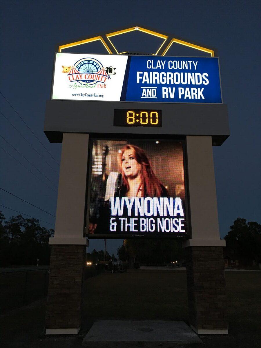 Clay County Fairgrounds pylon sign with Daktronics LED display at night, installed by CG Signs