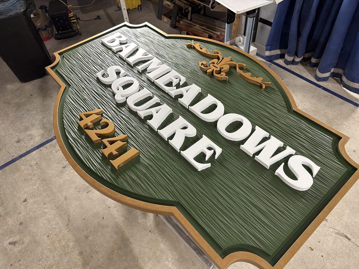 HDU sign panel with textured background, raised letters, and painted finish — Custom Graphics & Sign Designs