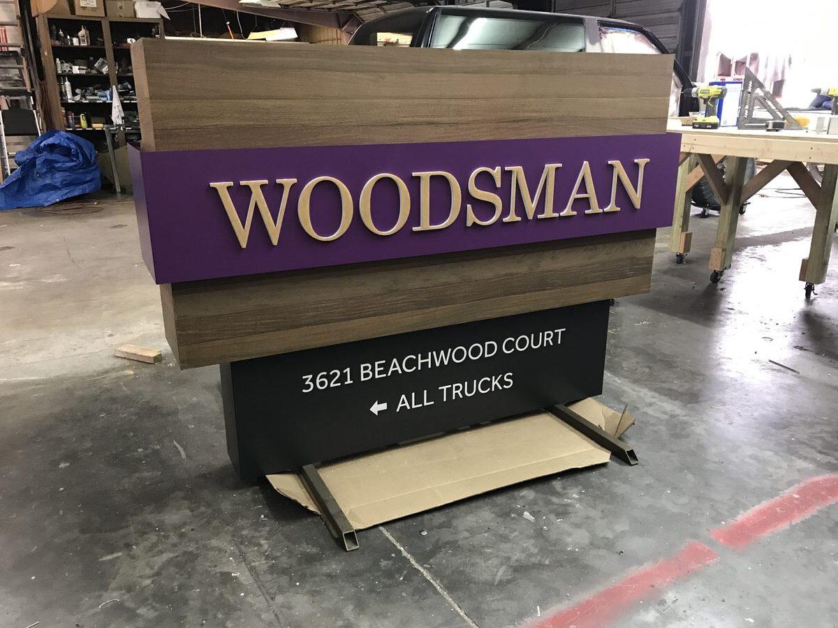 Woodsman monument sign during fabrication — Ipe wood accents being assembled before final install, CG Signs