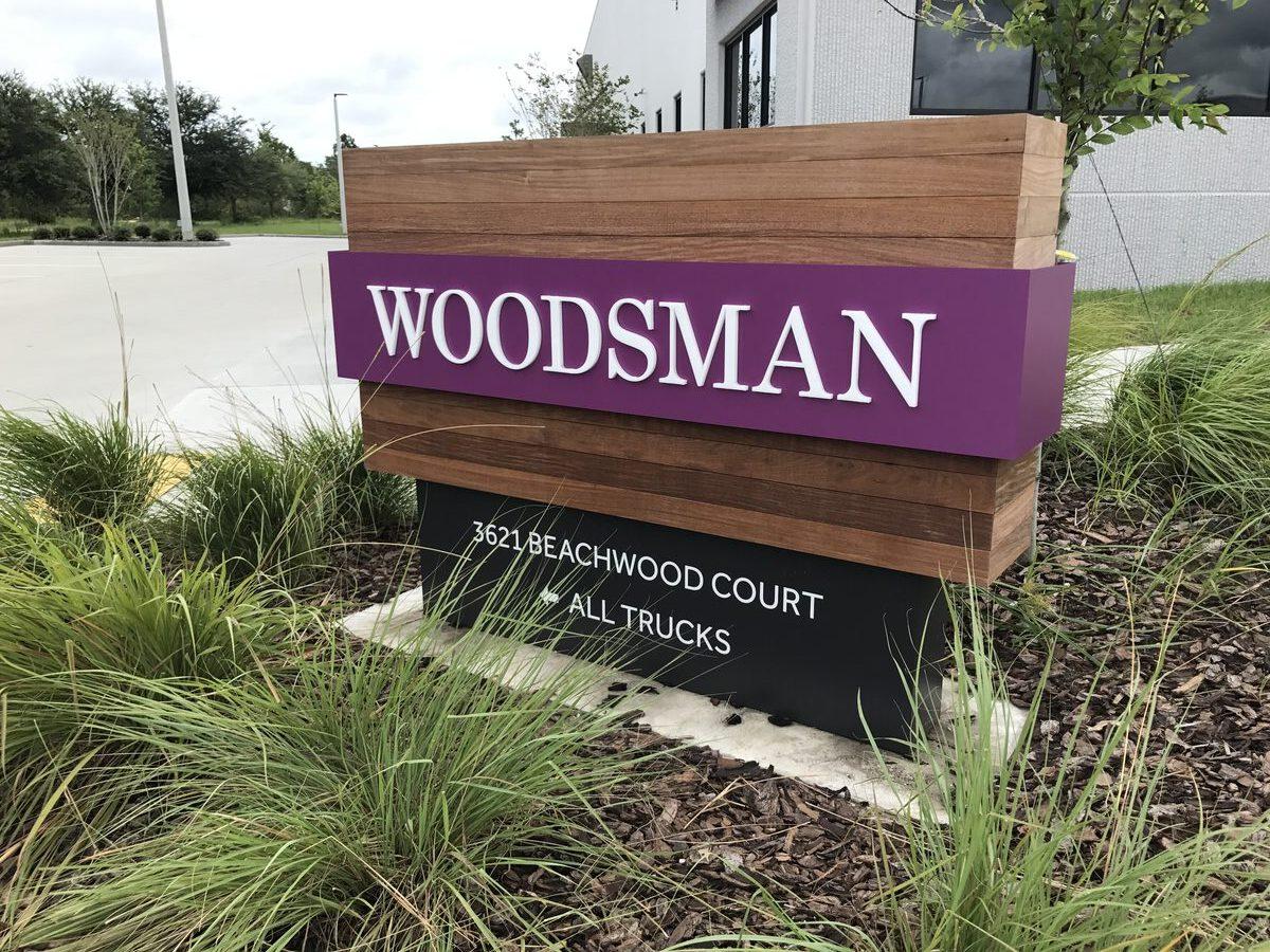 Installed Woodsman monument sign with Ipe Wood accents and acrylic letters — CG Signs