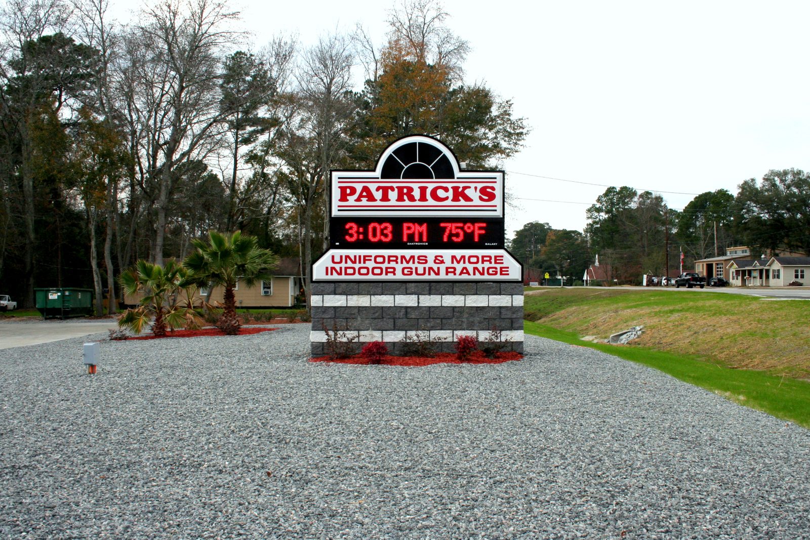 The first Daktronics LED message center installed by CG Signs — Patrick's Uniforms & More monument sign with red Galaxy display showing 3:03 PM and 75°F, photographed December 2007 in Garden City, Georgia (near Savannah)