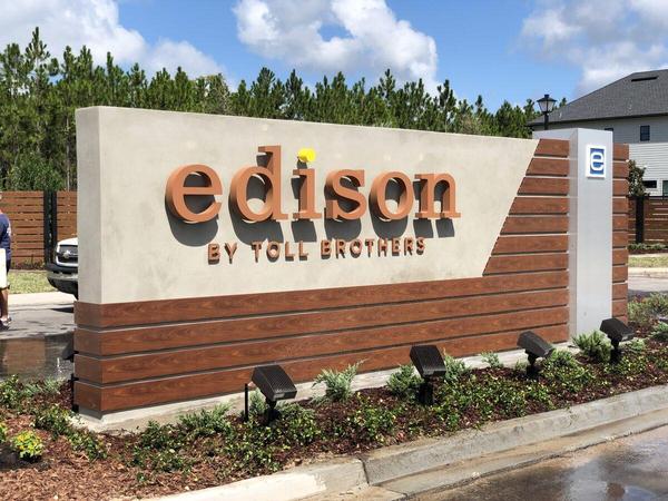 Custom Fabricated Monument Sign for Edison by Toll Brothers in eTown. Aluminum structure with concrete and stucco façade with Knotwood and Brushed aluminum accents. Halo-Lit reverse channel letters — Custom Graphics & Sign Designs
