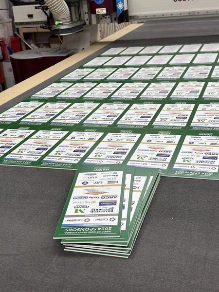 Custom printed PVC signs being cut to shape — Custom Graphics & Sign Designs, Jacksonville FL