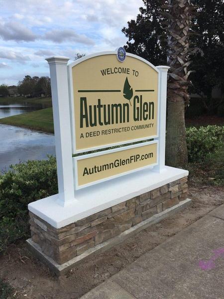Custom monument sign with aluminum posts and structure, HDU sign panels with Engraved Graphics, and a Stacked Stone masonary base — Custom Graphics & Sign Designs, Jacksonville FL