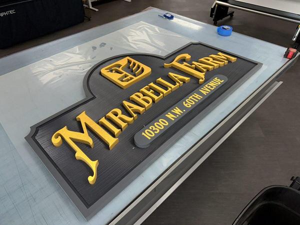 Carved HDU sign with textured background, raised letters, painted finish, and reflective vinyl accents — Custom Graphics & Sign Designs