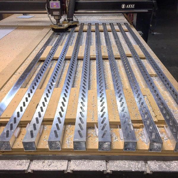 CNC cutting aluminum extrusion used for custom bahama shutters — Custom Graphics & Sign Designs, Northeast Florida