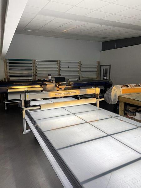 View of our Rolls Roller Flatbed Aplicator in our Graphics Production room — Custom Graphics & Sign Designs